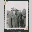 Man in uniform with group behind him (ddr-densho-434-74)