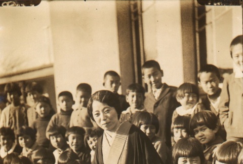 Satoko Matsudaira, an opera singer posing with school children (ddr-njpa-4-808)
