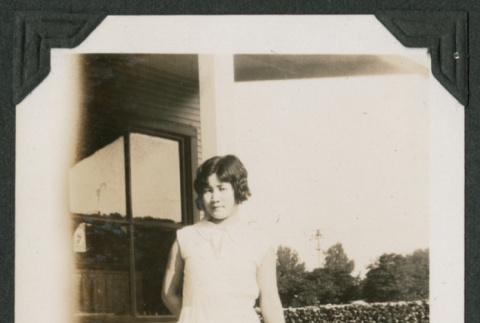 woman leaning against a pole (ddr-densho-378-600)