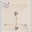 Woman standing with barracks in background (ddr-densho-464-119)