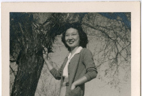 Mae Yoshiko (Miwa) Higaki standing by tree (ddr-densho-458-86)