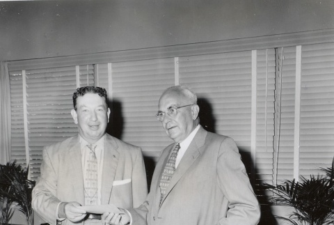 Sears executive giving a check to a University of Hawaii dean (ddr-njpa-2-1010)