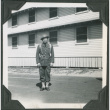 Man in uniform standing outside building (ddr-ajah-2-77)