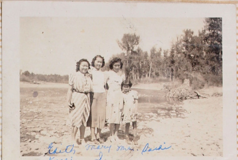 Three women and children standing alongside river (ddr-densho-464-81)