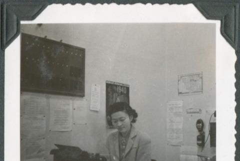 A woman typing in an office (ddr-densho-300-208)