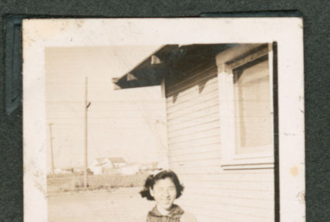 Woman in front of house (ddr-densho-550-292)