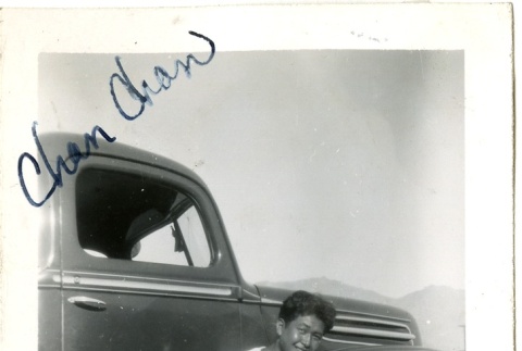 Signed photograph of a woman in front of a truck (ddr-manz-6-86)