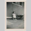Toddler girl sitting outside barracks (ddr-densho-329-1275)