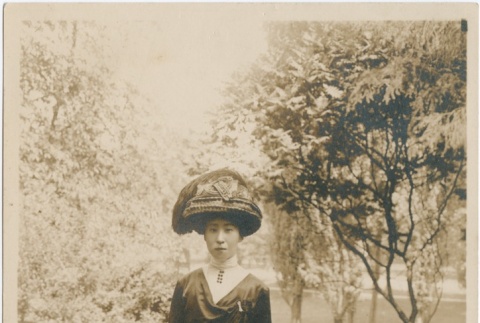 A woman standing in a park (ddr-densho-321-512)