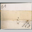 Small photo of a woman and a girl on a beach (ddr-densho-483-1311)