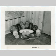 Photograph of farm products arranged in the corner of a building for the Manzanar farm exhibit (ddr-csujad-47-67)