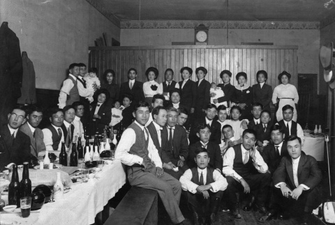 Two versions of group of men and women at a dinner, one with individuals identified (ddr-ajah-6-754)