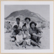 Two women, a man and four children on beach (ddr-densho-522-358)