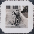 Couple sitting on steps in front of house (ddr-densho-467-16)