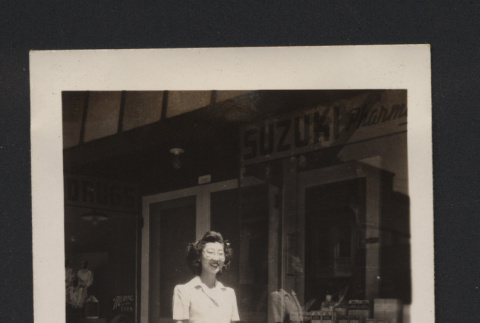 Photograph of Suzuki family member in front of Suzuki Pharmacy (ddr-csujad-55-2649)