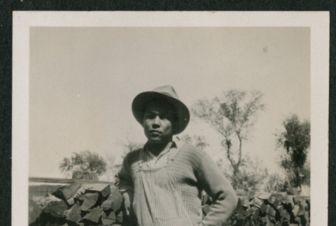man by wood pile (ddr-densho-378-358)