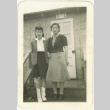 Mother and daughter in front of barracks (ddr-densho-118-11)