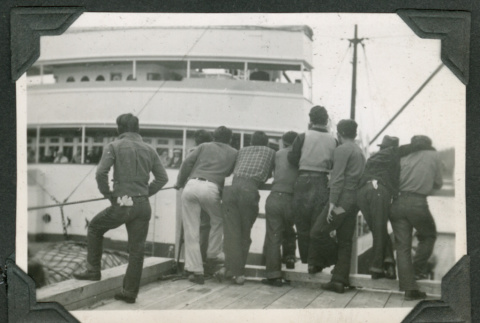 Group of men peering at ship (ddr-densho-540-61)