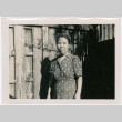 Woman standing by fence (ddr-densho-426-1122)