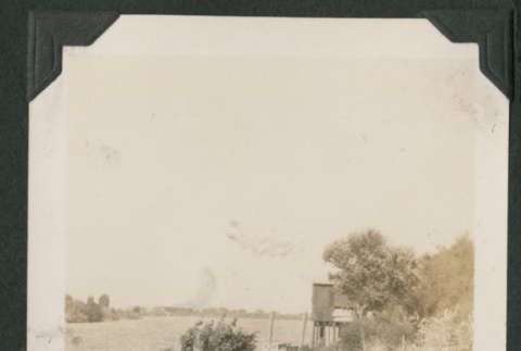 woman sitting on railing (ddr-densho-378-513)