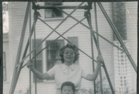 Agnes Sakura with boy on swing (ddr-densho-523-213)