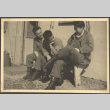 Three men sitting on bench outside building (ddr-densho-466-38)