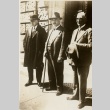 Three men standing outside a building (ddr-njpa-1-2359)