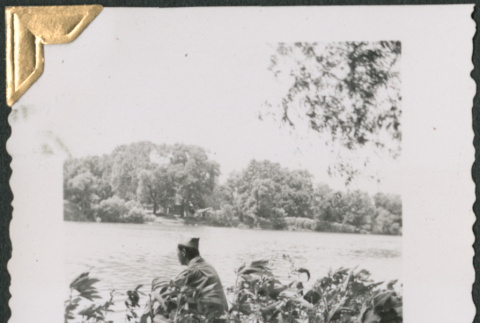 Man sitting on bank of river (ddr-densho-434-269)