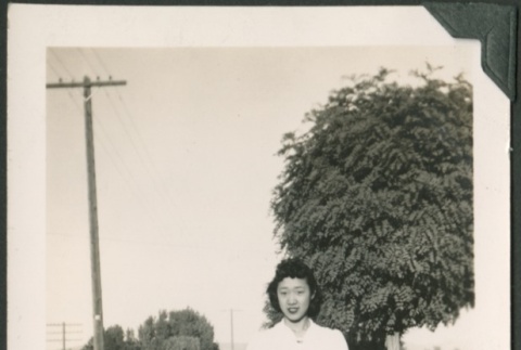 A woman standing in a field (ddr-densho-328-420)