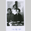 Three people pose at dinner table (ddr-densho-292-57)
