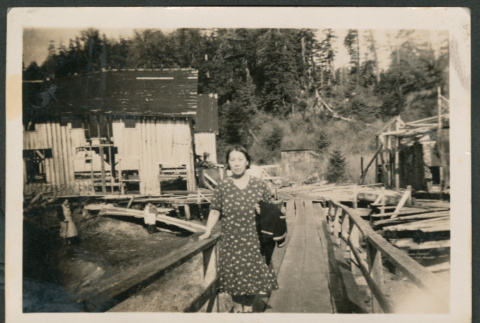 Photo of a woman on a wooden walkway (ddr-densho-483-360)