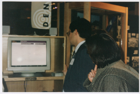 Museum goers looking at Densho workstations at the Wing Luke Asian Museum (ddr-densho-506-133)
