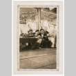 Four men sitting at fruit stand photo (ddr-densho-540-21)