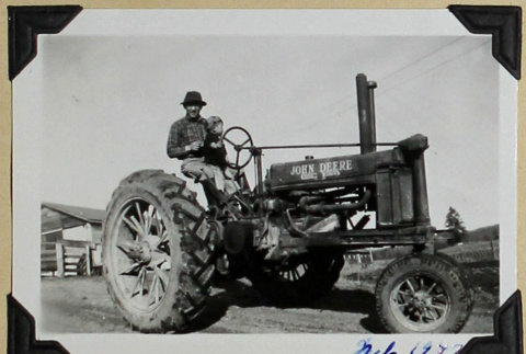 Man and child on tractor (ddr-densho-359-1636)