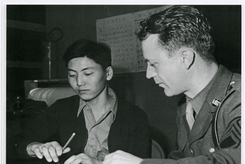 Young Japanese American signing voluntary enlistment papers (ddr-densho-122-752)