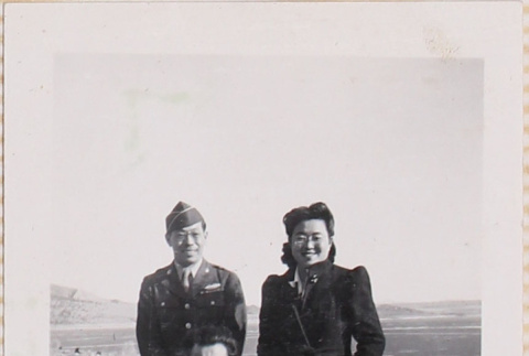 Two men and a woman standing outside in open field (ddr-densho-464-104)