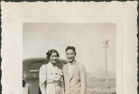 A couple posing in front of a car (ddr-densho-316-10)