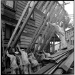 Group of men lifting framing alongside building (ddr-densho-426-2162)