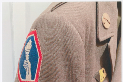 Close up of shoulder of military jacket with Go For Broke insignia (ddr-densho-539-147)