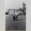 Man and boy in yard outside house (ddr-densho-522-61)