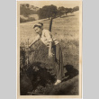Woman standing by water tap in field (ddr-densho-426-214)