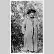 Figure outside in coat and hat (ddr-densho-1007-57)