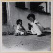 Susan Shiomi with William  Shiomi showing her how to play with a toy gun (ddr-densho-522-270)