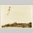 Airplane trail in the sky over a walled city (ddr-njpa-13-212)