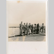 Group standing on deck of ship by railing (ddr-densho-426-2147)