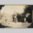 Girl sitting on grass with paper parasol (ddr-densho-423-497)