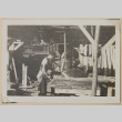 Man cutting wood (ddr-densho-433-670)