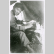 Man at table in tent (ddr-densho-1007-855)