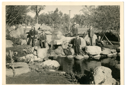 Photograph of seven men next to Pleasure Park pond at Manzanar (ddr-csujad-47-80)