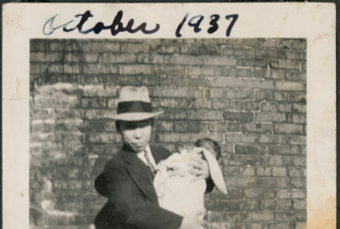 Man with toddler, holding baby (ddr-densho-483-699)